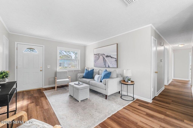 living room featuring crown molding, dark hardwood / wood-style flooring, and a textured ceiling