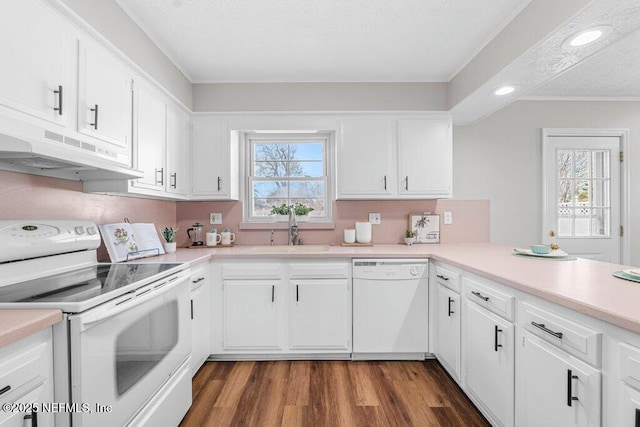 kitchen with sink, white appliances, white cabinetry, and a textured ceiling