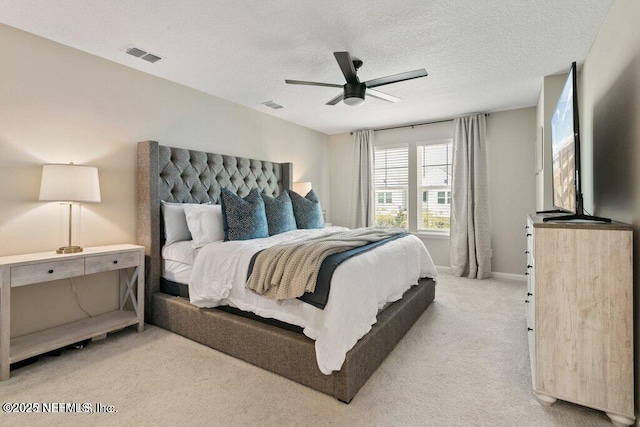 carpeted bedroom with ceiling fan and a textured ceiling