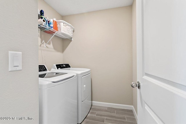 washroom featuring washing machine and clothes dryer and wood-type flooring