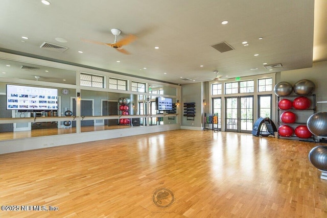 workout area featuring light wood-type flooring, ceiling fan, and french doors