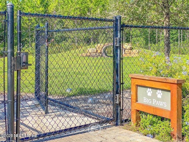 view of gate with a yard