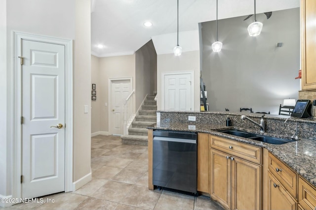 kitchen with sink, pendant lighting, ornamental molding, and dark stone countertops