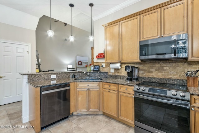 kitchen featuring pendant lighting, stainless steel appliances, dark stone countertops, sink, and kitchen peninsula