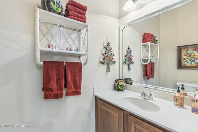 bathroom featuring vanity and toilet