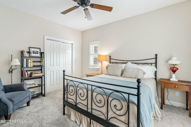 carpeted bedroom featuring a closet and ceiling fan