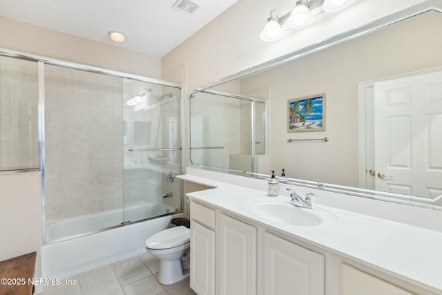 full bathroom with vanity, toilet, enclosed tub / shower combo, and tile patterned floors