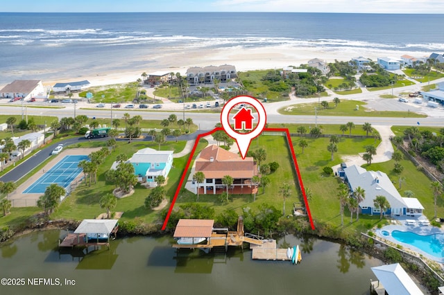 drone / aerial view featuring a water view and a beach view