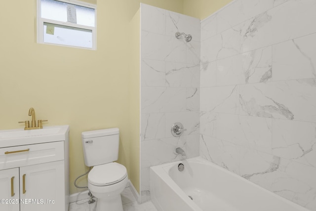 full bathroom featuring tiled shower / bath, vanity, and toilet