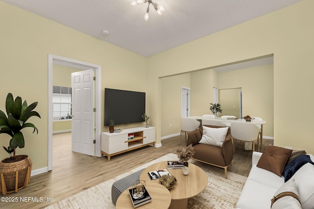 living room with light hardwood / wood-style flooring and a textured ceiling