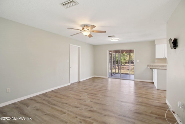 unfurnished living room with light hardwood / wood-style floors and ceiling fan