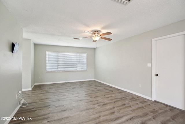 unfurnished room with hardwood / wood-style flooring, a textured ceiling, and ceiling fan