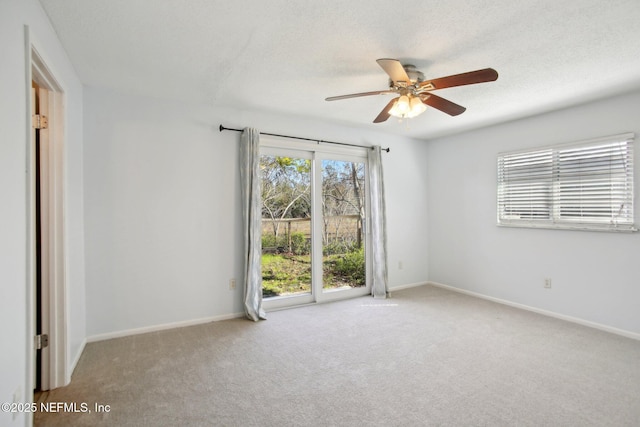 spare room featuring light carpet and ceiling fan