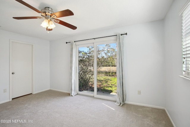 empty room with light colored carpet and ceiling fan