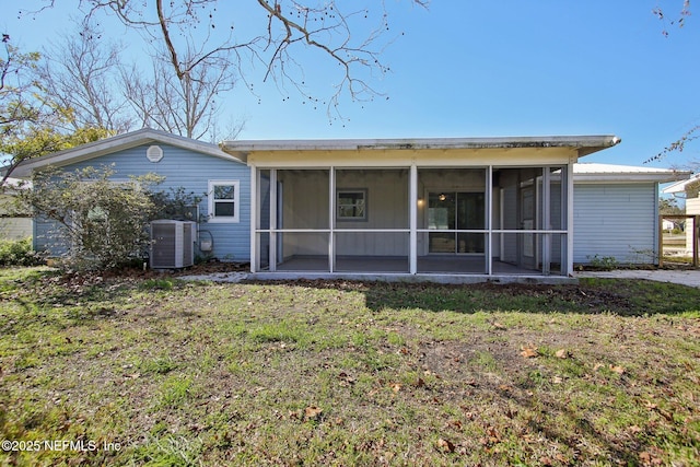 back of property featuring a sunroom, a yard, and cooling unit