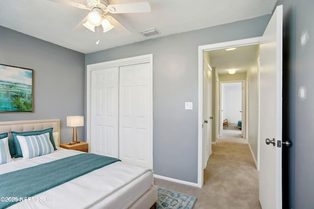 carpeted bedroom featuring a closet and ceiling fan