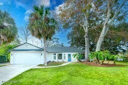 ranch-style house with a garage and a front yard