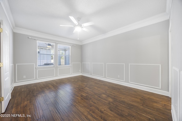 empty room with crown molding, dark hardwood / wood-style floors, and ceiling fan