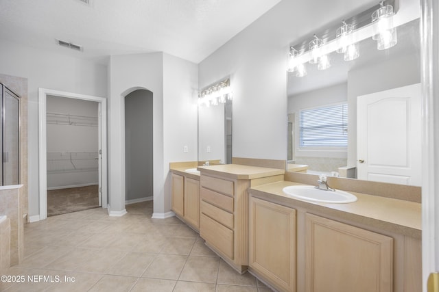 bathroom featuring vanity, tile patterned floors, and separate shower and tub