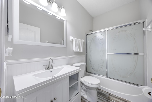 full bathroom featuring enclosed tub / shower combo, hardwood / wood-style floors, vanity, and toilet