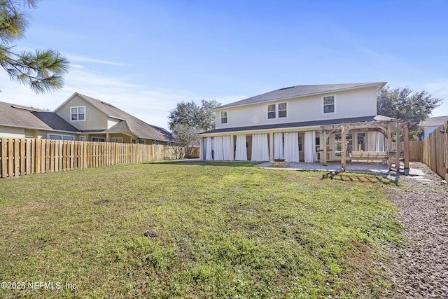 back of property featuring a yard, a pergola, and a patio area