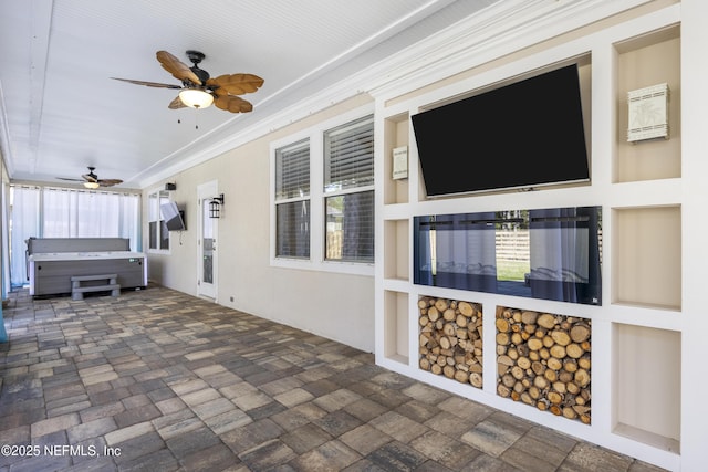 view of patio / terrace featuring ceiling fan and ornamental molding