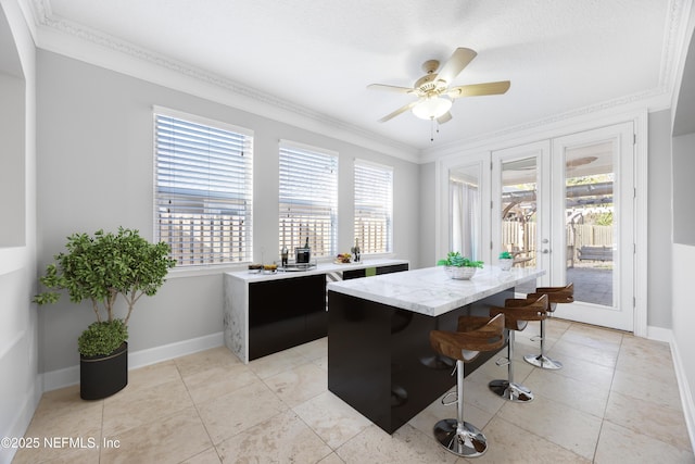 tiled office space featuring crown molding, french doors, and ceiling fan