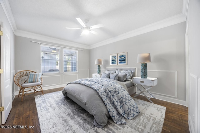 bedroom with ceiling fan, ornamental molding, dark hardwood / wood-style floors, and a textured ceiling