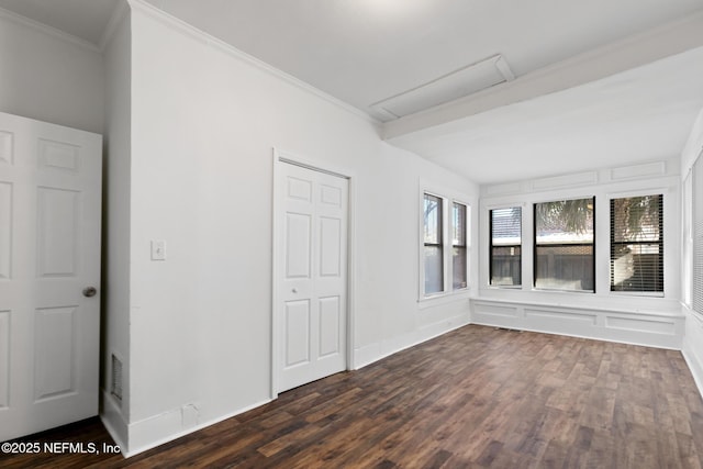 interior space with dark wood-type flooring and ornamental molding