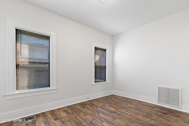 spare room featuring dark wood-type flooring