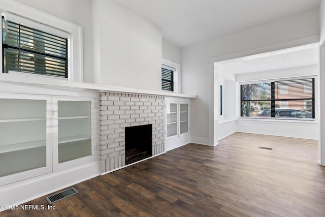 unfurnished living room featuring a fireplace and wood-type flooring