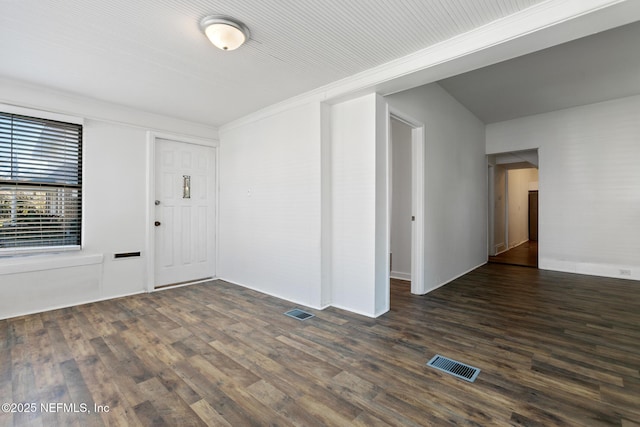 spare room featuring crown molding and dark hardwood / wood-style floors