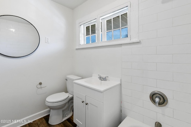 full bathroom with vanity, hardwood / wood-style floors,  shower combination, and toilet