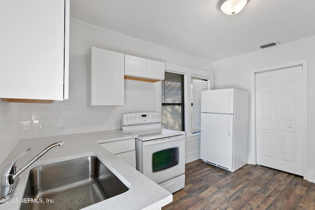 kitchen with dark wood-type flooring, sink, white cabinetry, range, and white fridge