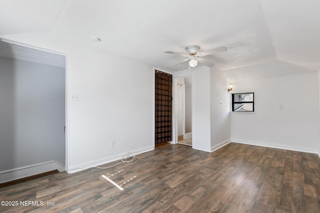 empty room with dark wood-type flooring, ceiling fan, and lofted ceiling