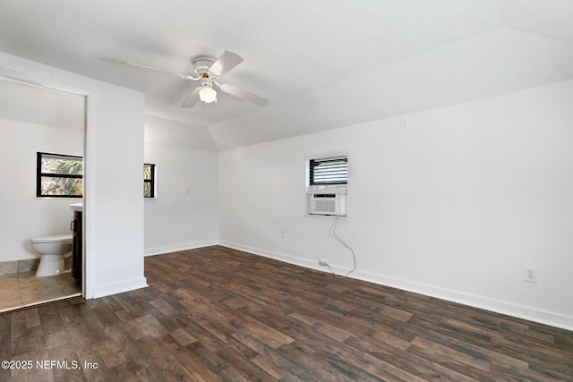 empty room featuring dark wood-type flooring, ceiling fan, a healthy amount of sunlight, and lofted ceiling