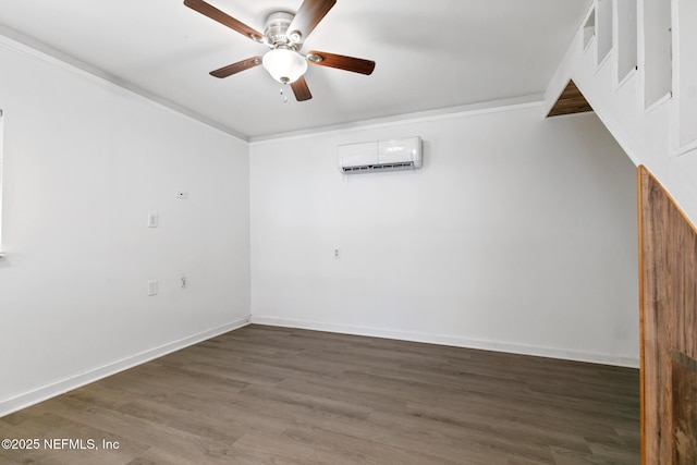 spare room featuring ceiling fan, ornamental molding, a wall mounted air conditioner, and dark hardwood / wood-style flooring