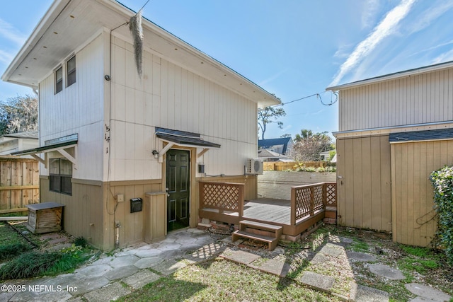 back of house featuring a wooden deck