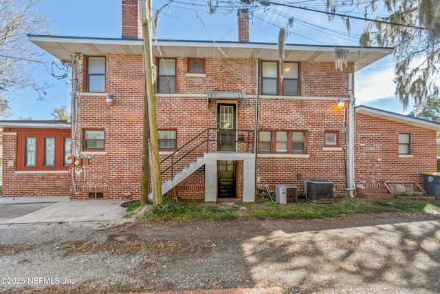 rear view of property with central AC unit