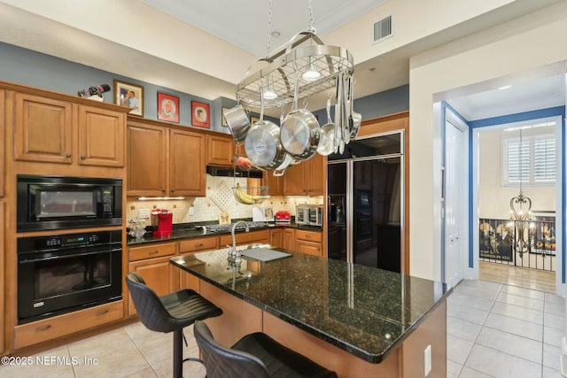 kitchen with crown molding, light tile patterned floors, visible vents, a chandelier, and black appliances