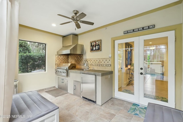 kitchen featuring decorative backsplash, stainless steel built in fridge, french doors, wall chimney range hood, and stainless steel counters