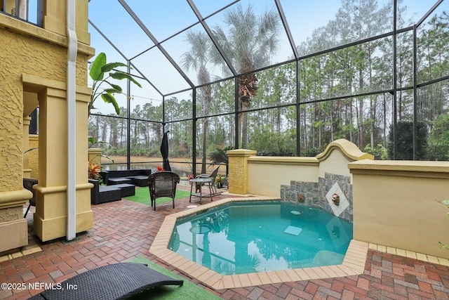 view of swimming pool featuring glass enclosure, an outdoor hangout area, and a patio