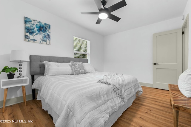 bedroom with hardwood / wood-style flooring and ceiling fan