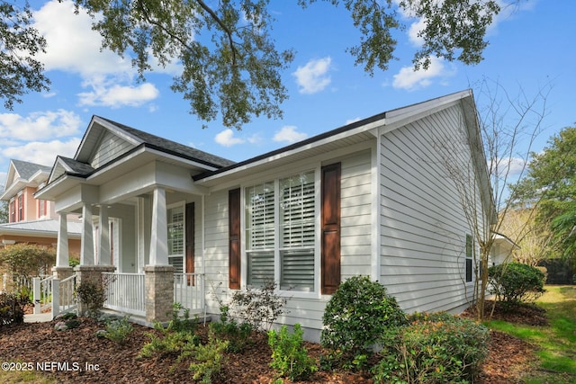 view of side of property with a porch