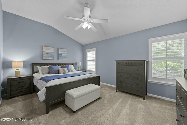 bedroom featuring vaulted ceiling, light carpet, and ceiling fan