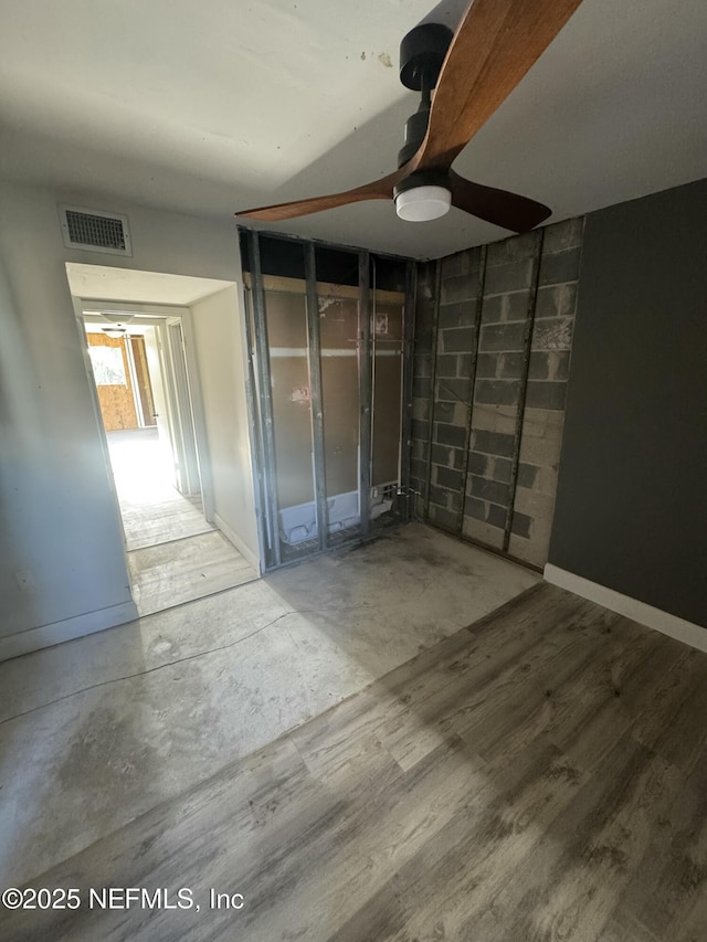 5500 Ocean Shore Blvd Unit 61, Ormond Beach, FL 32176 - interior space featuring baseboards, concrete block wall, visible vents, and wood finished floors