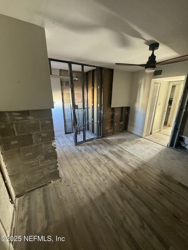 5500 Ocean Shore Blvd Unit 61, Ormond Beach, FL 32176 - unfurnished living room with visible vents, floor to ceiling windows, wood finished floors, and a ceiling fan