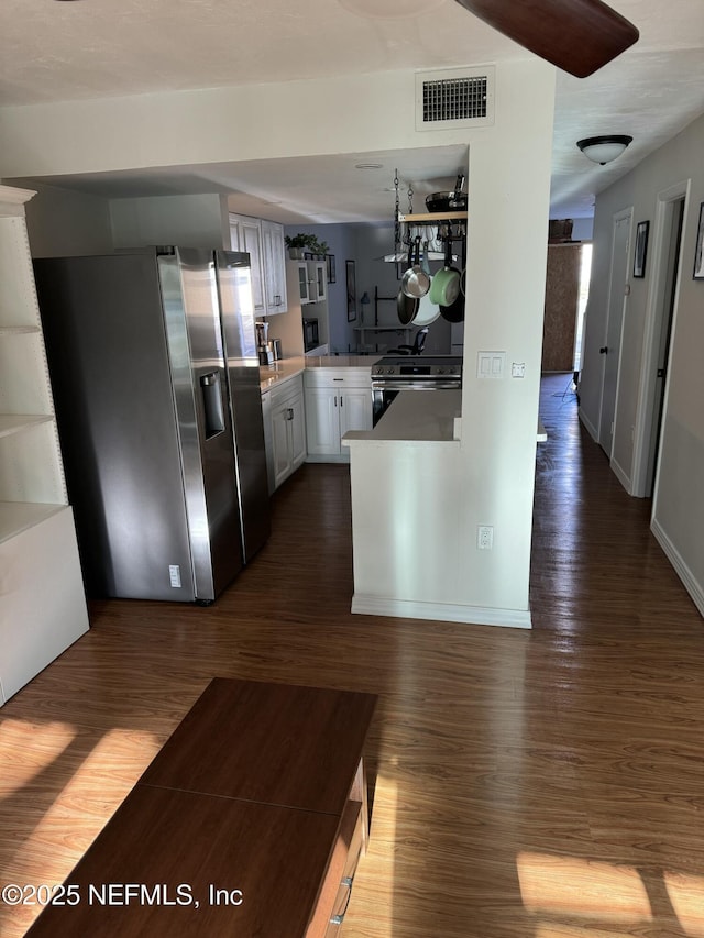 5500 Ocean Shore Blvd Unit 61, Ormond Beach, FL 32176 - kitchen featuring white cabinetry, appliances with stainless steel finishes, a peninsula, dark wood-style floors, and visible vents