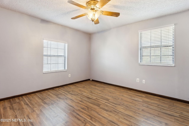 empty room with hardwood / wood-style floors, a textured ceiling, and ceiling fan