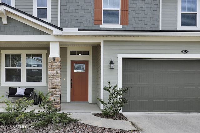 doorway to property with a garage